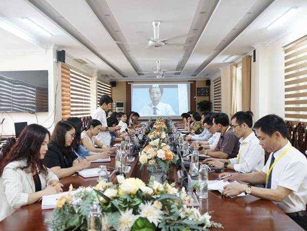 A group of people sitting at a long table

Description automatically generated